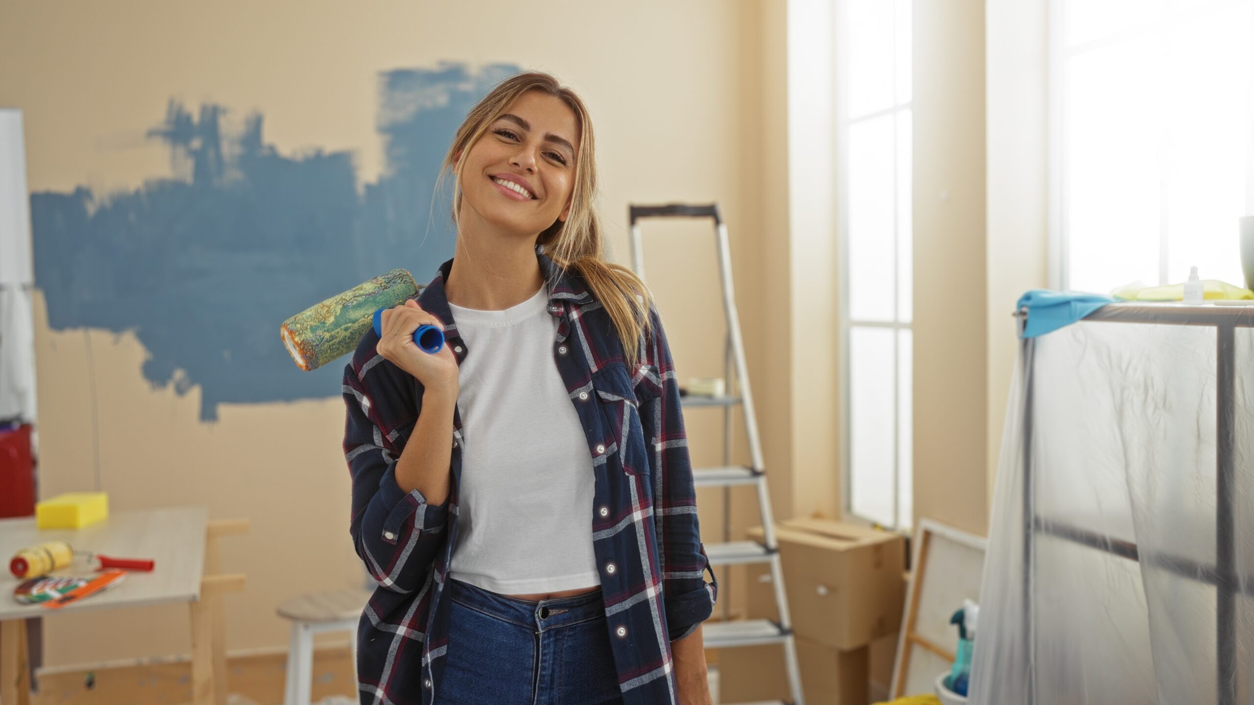 Woman,Smiling,Indoors,Holding,A,Paint,Roller,In,A,Well-lit renovation flat